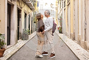 Senior Couple Holding Hands Enjoying Vacation Posing On Lisbon Street