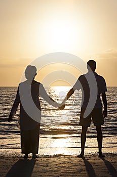 Senior Couple Holding Hands Sunset Tropical Beach