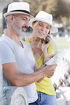 senior couple on holiday looking at tourist map