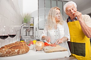 SENIOR COUPLE AT HOME IN THE KITCHEN
