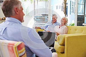 Senior Couple At Home Meeting With Financial Advisor