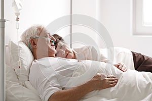 Senior couple on hospital bed