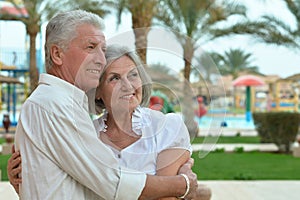 Senior couple at hotel resort hugging