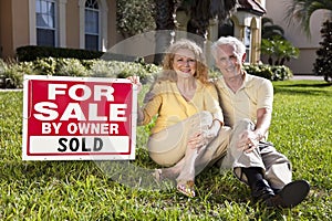 Senior Couple and House For Sale Sold Sign