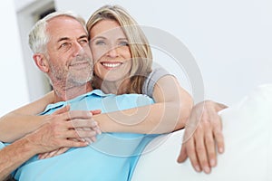 Senior couple, hug and happy portrait with love at home for trust, care and support for retirement. Commitment of man