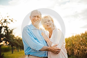 Senior couple hugging each other outdoors