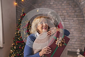 Senior couple hugging after exchanging Christmas presents