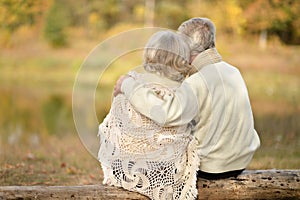 Senior couple hugging outdoors