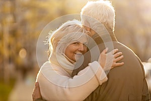 Senior couple hugging outdoors