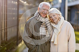 Senior couple hugging outdoors