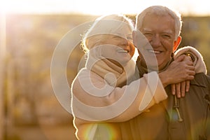 Senior couple hugging outdoors