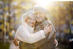 Senior couple hugging outdoors