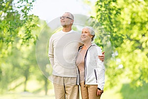 Senior couple hugging over natural background