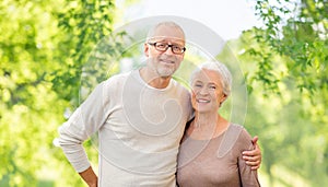 Senior couple hugging over natural background