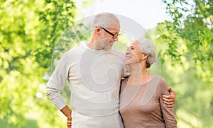 Senior couple hugging over natural background