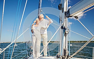 Senior couple hugging on sail boat or yacht in sea