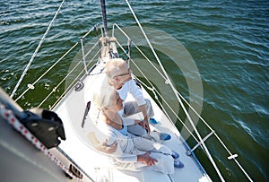 Senior couple hugging on sail boat or yacht in sea