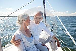 Senior couple hugging on sail boat or yacht in sea