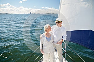 Senior couple hugging on sail boat or yacht in sea