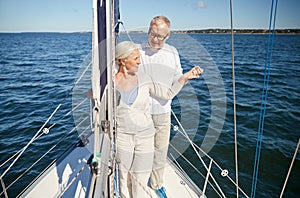 Senior couple hugging on sail boat or yacht in sea