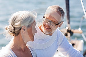 Senior couple hugging on sail boat or yacht in sea