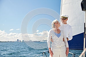 Senior couple hugging on sail boat or yacht in sea