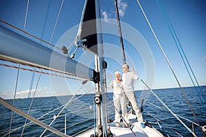 Senior couple hugging on sail boat or yacht in sea