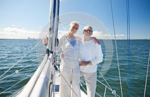 Senior couple hugging on sail boat or yacht in sea