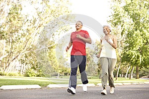 Senior Couple Jogging In Park