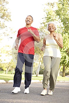 Senior Couple Jogging In Park