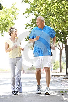 Senior Couple Jogging In Park