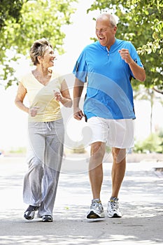 Senior Couple Jogging In Park