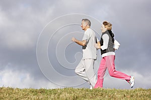 Senior Couple Jogging In The Park