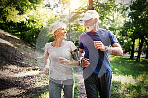 Senior couple jogging and running outdoors in nature