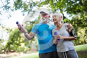 Senior couple jogging and running outdoors in nature