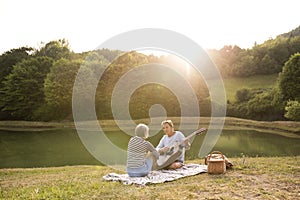 Senior couple at the lake having a picnic.