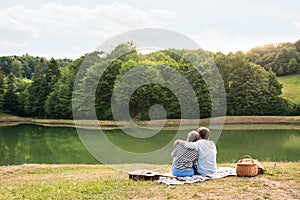 Senior couple at the lake having a picnic