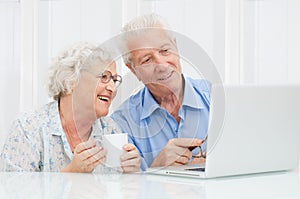 Senior couple at laptop