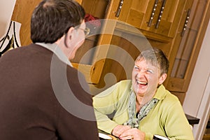 Senior couple laughing together in kitchen