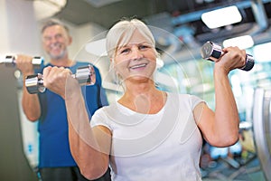 Senior couple lifting dumbbells