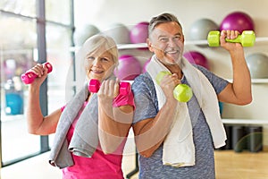 Senior couple lifting dumbbells