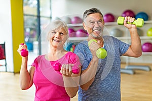 Senior couple lifting dumbbells