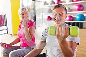 Senior couple lifting dumbbells