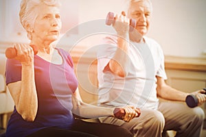 Senior couple lifting dumbbells