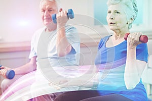 Senior couple lifting dumbbells