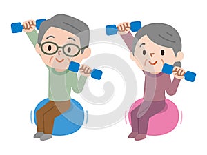 Senior couple lifting dumbbells while sitting on exercise ball
