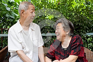 A senior couple look at each other.