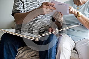 Senior couple looking at family photo album photo