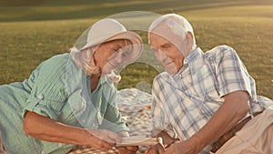 Senior couple looking at photograph.