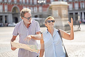 Senior couple lost using city map for finding their location in Europe
